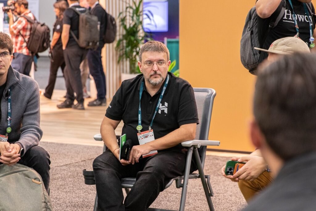 Marco Chiesi listening to a talk during a conference session